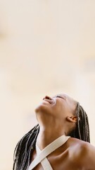Young black woman looking up smiling