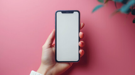 A female in fluffy and cozy sweater holding a modern smartphone white screen mockup over blurred office space.