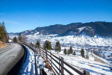 On a road in a village in Romania in winter. View from the countryside in a picturesque place
