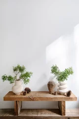 Rolgordijnen Rustic wooden bench with plant branch in vase and home decor in living room © brizmaker