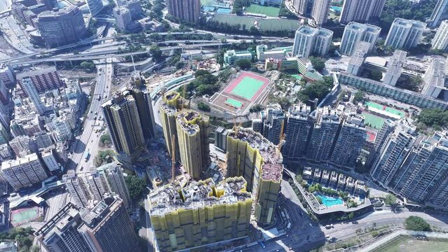 Railway Superstructure Property development Construction Project built on a hillside slope peak in Ho Man Tin Hung Hom To Kwa Wan, aerial skyview of the skyline of Hong Kong Victoria Harbour 