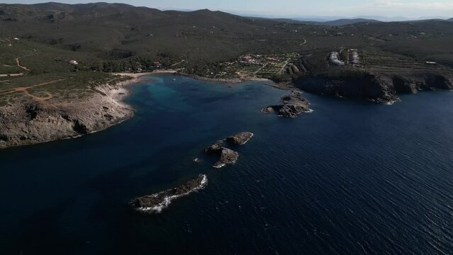 Aerial view of Cala Sapone, S. Antioco bay in Sardinia. Crystal clear sea, moored boat and white sand.