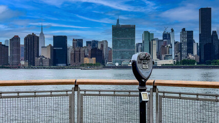 Strolling along the pier viewer and observer with binoculars of Long Island is an island that...