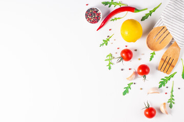 White cooking background with spices, vegetables and utensils. Top view. Free space for your text.