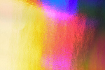 Holographic abstract background photo. Bright colourful gradient in pink, red, yellow, purple, blue and red with soft blur effect. Textured hologram effect.