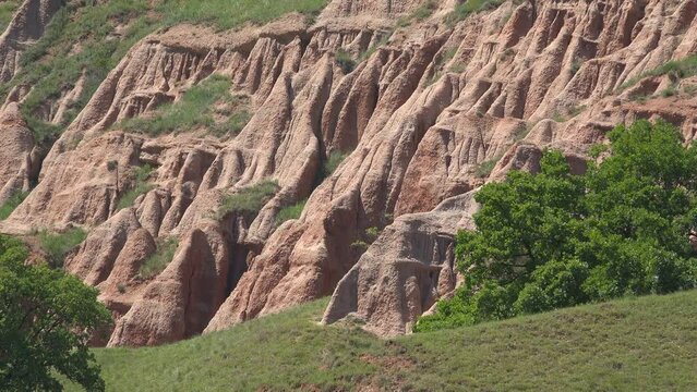 The Red Ravine (Rapa Rosie) surrounded by green hills near Sebes in Romania