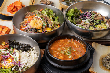 Korean food, soybean paste stew, spicy pork, bibimbap, side dishes, vegetables, kimchi, earthen pot,