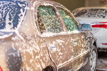 white foam soap on wind shield of vintage brown sedan car