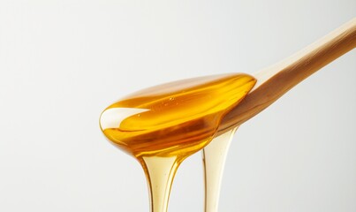 Honey dripping. Close up, honey dipping from the wooden honey spoon.