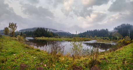 Fototapeta na wymiar Foggy and overcast autumn day in Carpathian Mountains. Rika river bend, Transcarpathia, Ukraine.