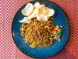 A common serving of regular fried rice in a blue ceramic plate.