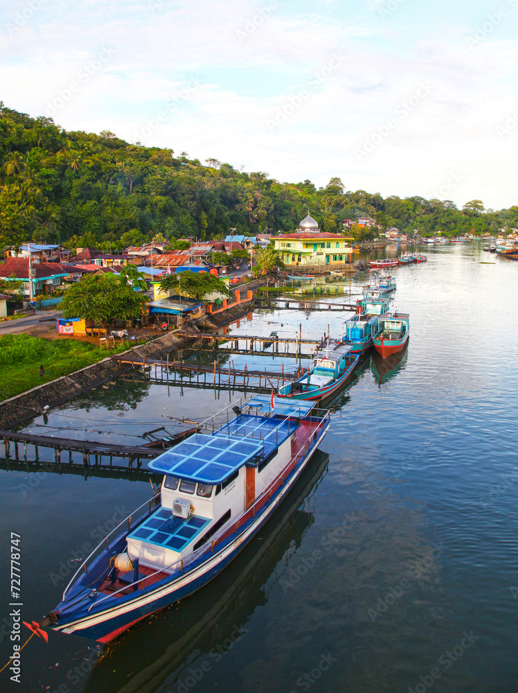 Wall mural colorful blue and red fishing boats in the batang arau river and port in padang city in west sumatra - Wall murals