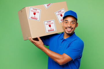 Delivery guy employee man wears blue cap t-shirt uniform workwear work as dealer courier hold blank...