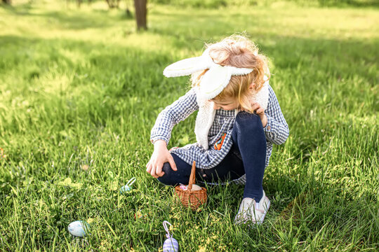 rejoicing in the feast of Easter and waiting to search for Easter eggs in the park among the grass. Easter egg hunt