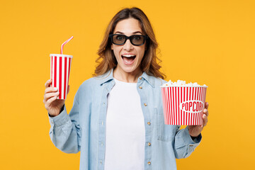 Young surprised fun woman wear blue shirt white t-shirt casual clothes 3d glasses watch movie film...