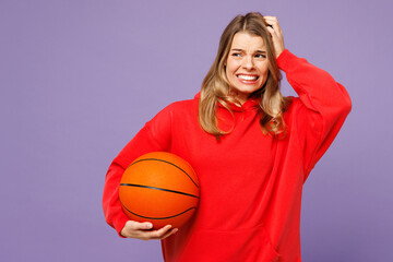 Young shocked sad dissatisfied woman fan wearing red hoody cheer up support basketball sport team...