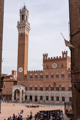 Fototapeta na wymiar SIENA, ITALY - SEPTEMBER 23, 2023 - The iconic Palazzo Pubblico at the Piazza del Campo in downtown Siena