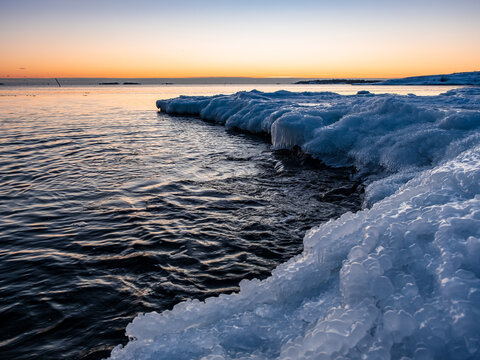 Sunset over the freezing sea at winter in Finland