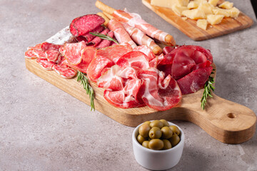 Charcuterie board. Antipasti appetizers of meat platter with salami, prosciutto crudo or jamon and olives.