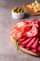 Charcuterie board. Antipasti appetizers of meat platter with salami, prosciutto crudo or jamon and olives.