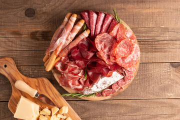 Charcuterie board. Antipasti appetizers of meat platter with salami, prosciutto crudo or jamon and olives.