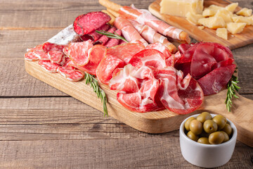 Charcuterie board. Antipasti appetizers of meat platter with salami, prosciutto crudo or jamon and olives.