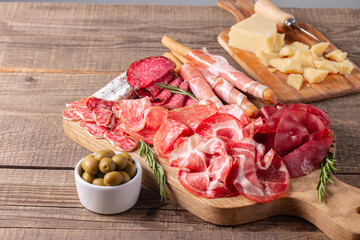 Charcuterie board. Antipasti appetizers of meat platter with salami, prosciutto crudo or jamon and...