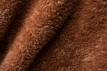 Texture of a brown faux fur as a background.