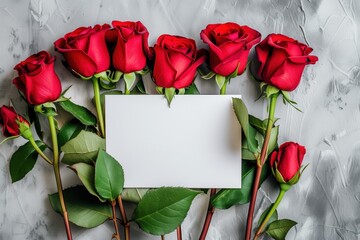 Mockup of a romantic letter featuring red roses and a blank white sheet of paper, captured from a top view in a flatlay arrangement.