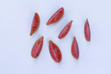 slices/pieces of red guava fruit on a white background, red guava is an alternative traditional medicine