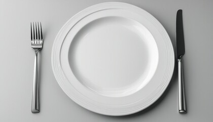 Clean empty white plate with knife and fork

