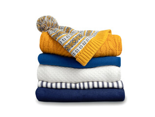 Stack of colorful knitted folded clothes isolated on white. Winter apparel,yellow blue knitwear.