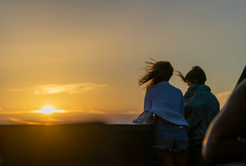 Serene Sunset Companionship: Two Friends Embracing the Evening Glow
