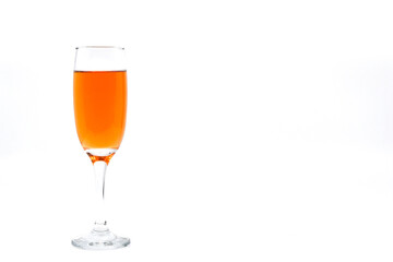 Flute glass of pink champagne isolated on a white background. Copy space to right. No people.