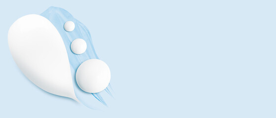 Set of smears of cream and drops of transparent gel on a blue background. Empty space