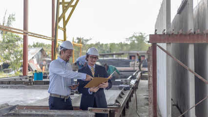 Factory owner discusses with his engineer to design for a new construction product. Supervisor provides technical advice to his manager in a factory - obrazy, fototapety, plakaty