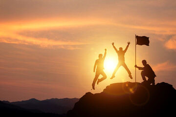 Success and achieving goals. Silhouette of businessman holding a trophy and flag on top of the mountain. concept of victory in competition Business and strategic planning for future business growth.