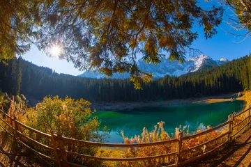 Papier Peint photo autocollant Mont Cradle Lago di Carezza, an alpine marvel with emerald waters, cradled by spruce trees, framed by the majestic Dolomites, a fairy tale woven into nature's enchanting panorama