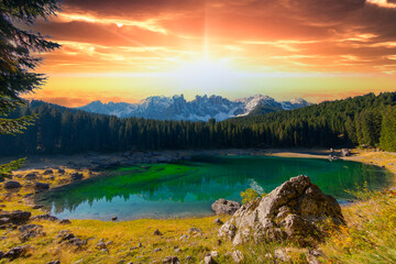 Lago di Carezza, an alpine marvel with emerald waters, cradled by spruce trees, framed by the majestic Dolomites, a fairy tale woven into nature's enchanting panorama