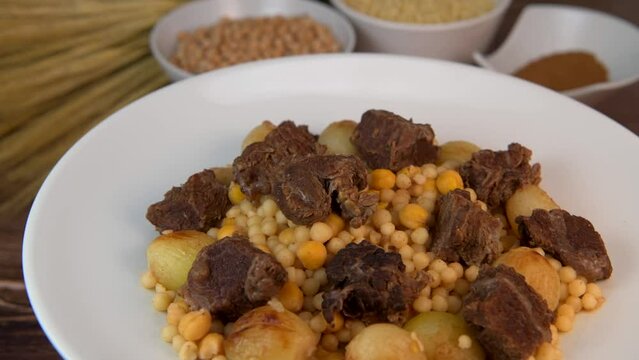 Moughrabieh is a popular dish in the Lebanese cuisine, LEBANESE RECIPE FOR MOUGHRABIEH WITH BEEF AND SMALL ONIONS, SEMOLINA PEARLS AND CHICKPEAS. High quality video