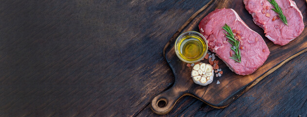 Banner Raw meat beef steak organic fresh ingredient on wooden board table background in kitchen...