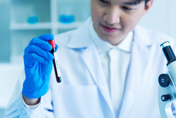 Close up Scientist man hands holding sample blood test tube science laboratory. Doctor clinic healthcare technician lab testing blood sample diagnosis. Crop man scientist hands testing medical lab