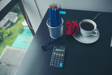 Top view office desk smart tablet document paper, coffee cup roses on wood table with copy space....