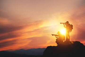 Vision for success ideas. businessman's perspective for future planning. Silhouette of man holding binoculars on mountain peak against bright sunlight sky background.