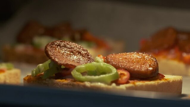 Cooking Homemade Pizza with Turkish Sausage Also Known as Sucuk in Oven. Sliced Meats Roasting Perfectly. Preparing for Meal Close Up Shot Slow Motion.
