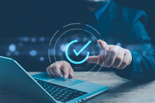 Businessman hand showing check mark digital technology icon symbol. Top quality assurance service concept, product performance assurance, and industry-leading ISO certification.