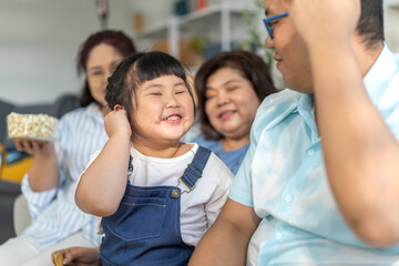Portrait of enjoy happy love asian family father and mother with cute little asian girl child smiling play and having fun moments good time, care, kid, support, insurance, child, at home