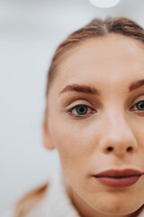 Head shot of stunning redhead woman with red lipstick on the lips and blue eyes. Close up.