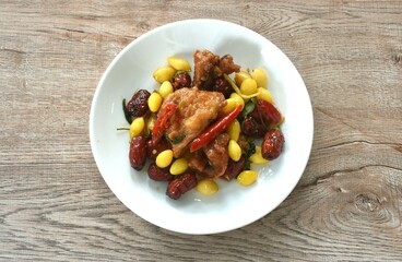 deep fried slice mango fish with yellow ginkgo and pickled jujube couple black mushroom in sweet sour sauce on plate 