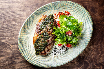 Grilled Ribeye Steak on plate with salad